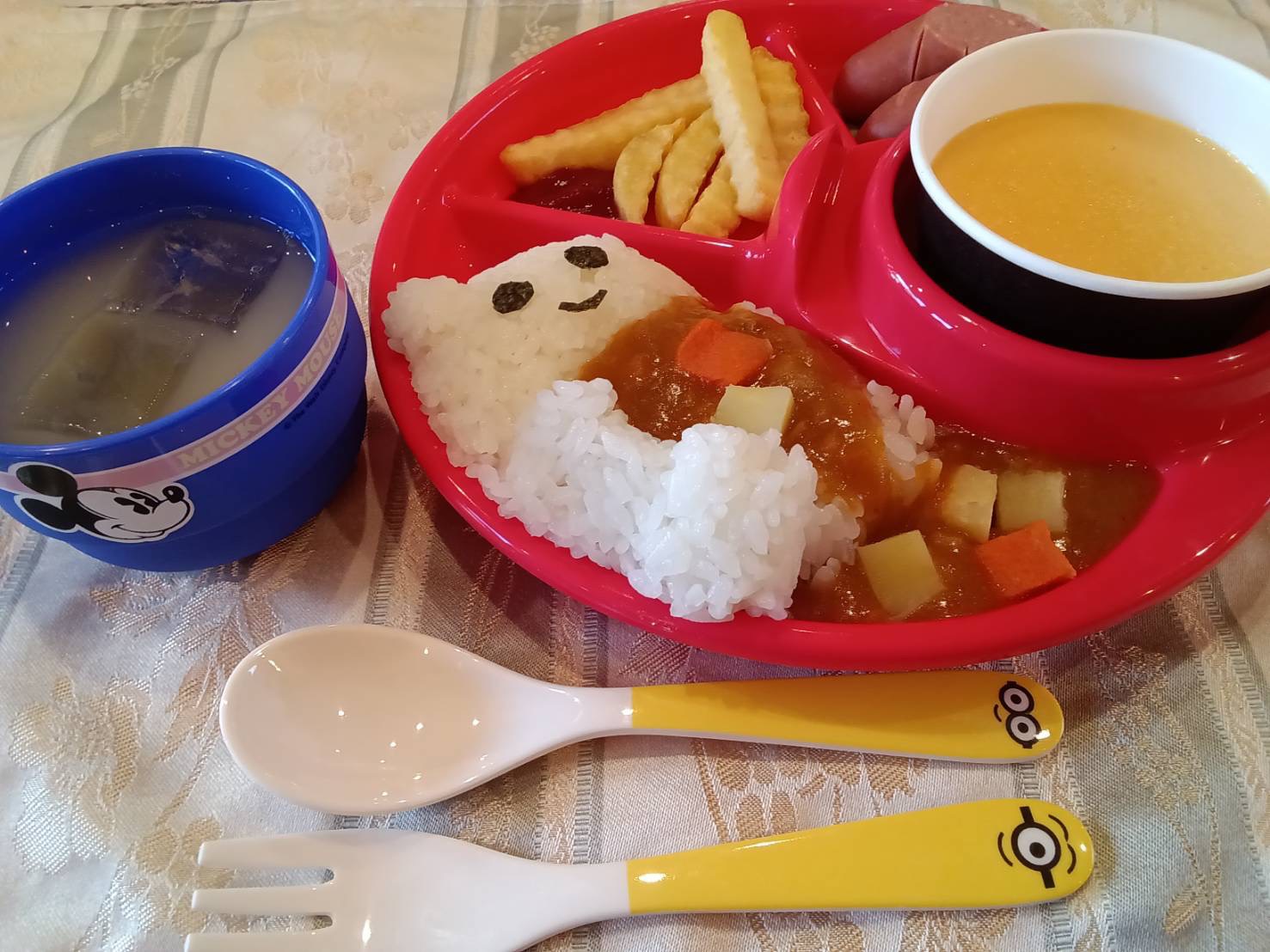 顔の形のごはんにカレー、ポテト、スープを添えたお子様カレー